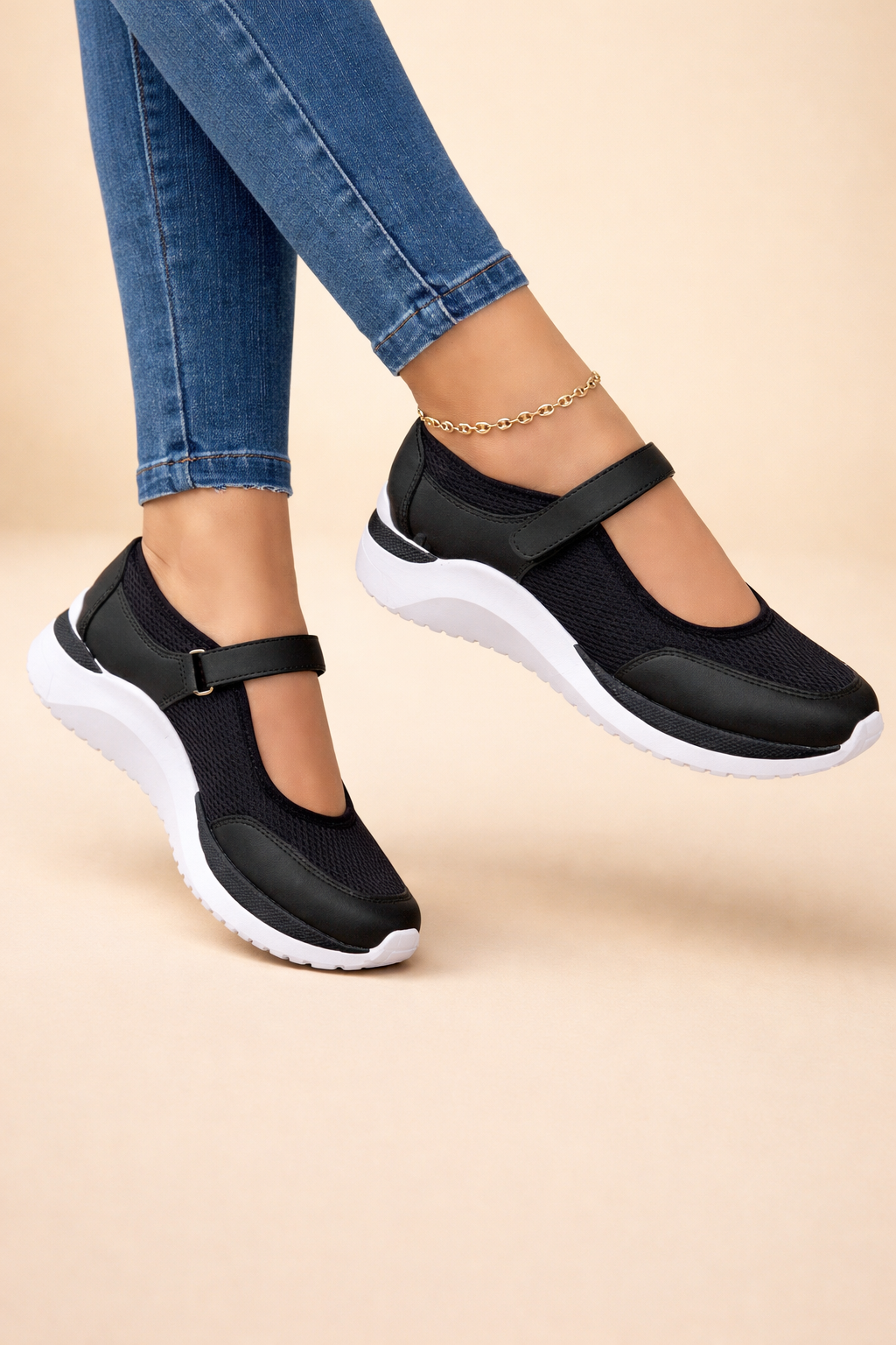 Women's white mary jane sneakers with buckled strap and mesh upper