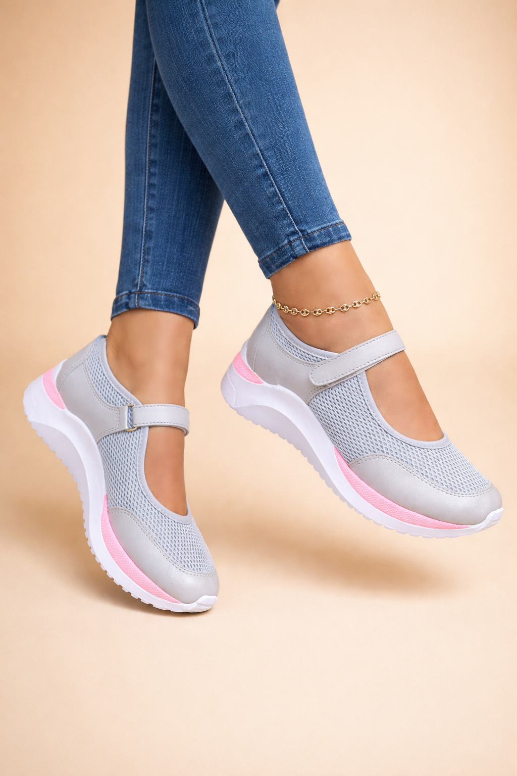 Women's white mary jane sneakers with buckled strap and mesh upper