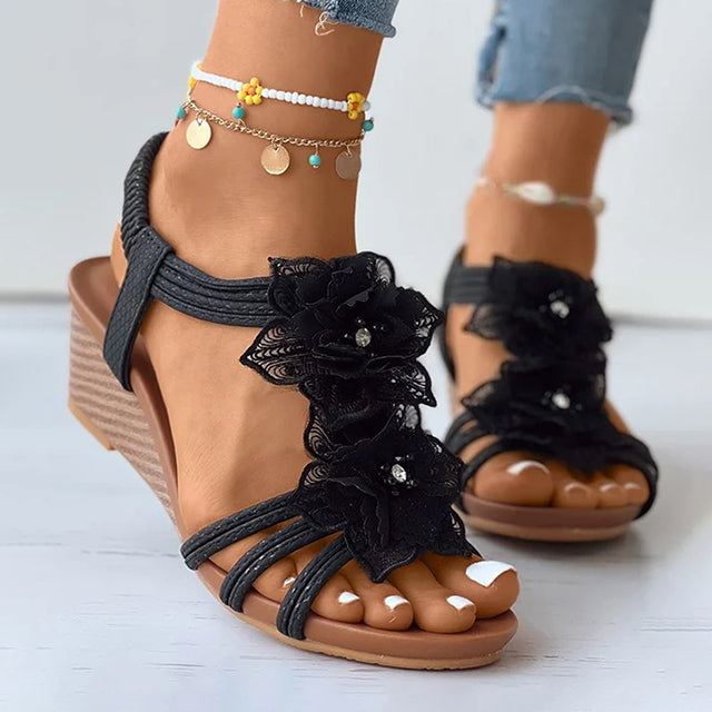 Women's black floral wedge sandals with mid heel and open toe